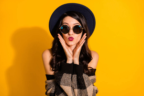 Photo of funky happy young woman pouted lips hold hands face cheekbones isolated on yellow color background - Valokuva, kuva