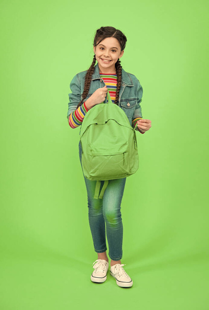 For the wanderlust in you. Happy kid hold backpack green background. Traveling and wanderlust. Wander and discover. Wanderlust concept. Summer vacation. Adventure and discovery. School holidays - Fotó, kép