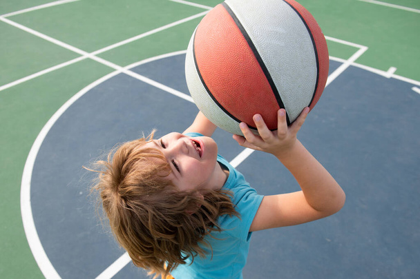 Portrait of little boy play basketball. Concept of kids sports. - Foto, imagen