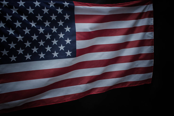 Closeup of waved USA flag over dark background - Foto, afbeelding