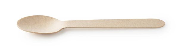Un semplice cucchiaio di legno usa e getta posto su uno sfondo bianco - Foto, immagini