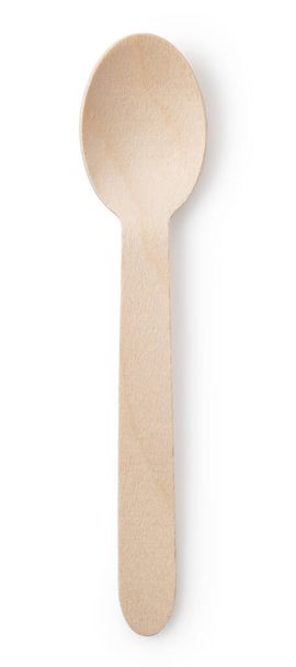 Un cucchiaio di legno monouso semplice impostato su uno sfondo bianco. Vista direttamente dall'alto. - Foto, immagini