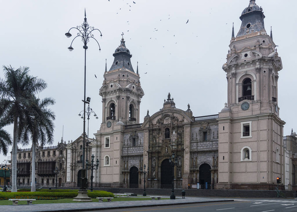 Lima main square empty during pandemic times, view of Lima cathedral , Archbishop Palace, palms in main square - Foto, Imagen