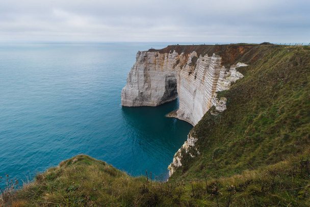 The famous Etretat Aval cliff and natural arch landmark by the ocean in Normandy, France - Фото, изображение
