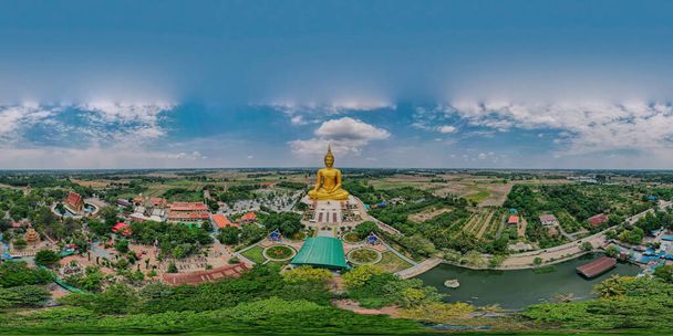 360 degrees panorama aerial view of big ancient golden mediated Buddha at Wat Muang Temple, Ang Thong province, Thailand, drone high angle top view - Foto, immagini