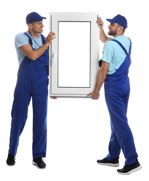 Workers with plastic window on white background. Installation service - Photo, image