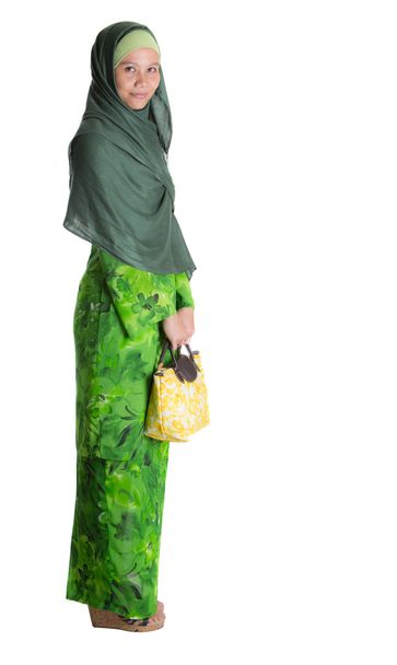 Mujer musulmana en vestido verde con bolso amarillo
 - Foto, imagen