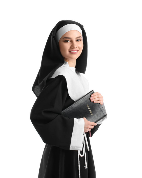 Young nun with Bible on white background - Foto, Bild