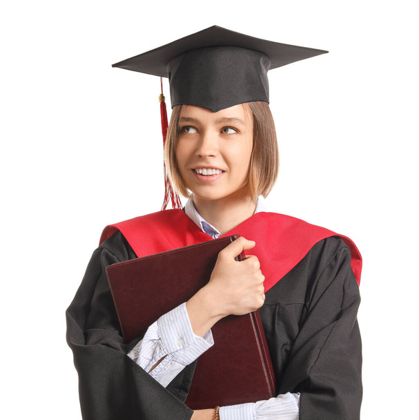 Female graduating student with book on white background - Photo, Image
