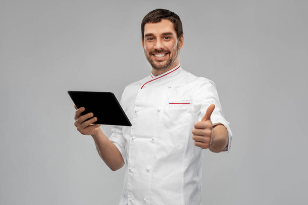 happy male chef with tablet pc showing thumbs up - Foto, Imagen