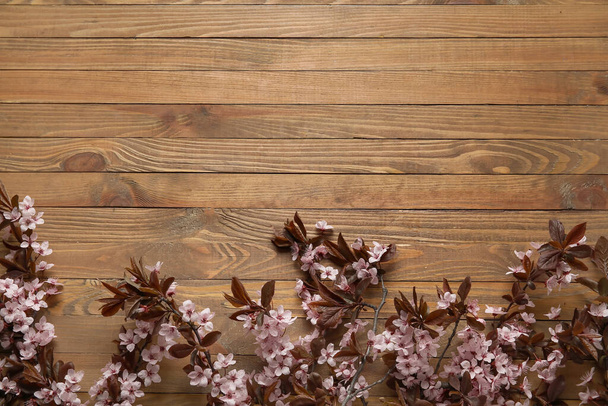 Beautiful blossoming branches on wooden background - Zdjęcie, obraz