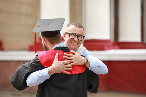 Happy young man with his father on graduation day - Foto, Bild