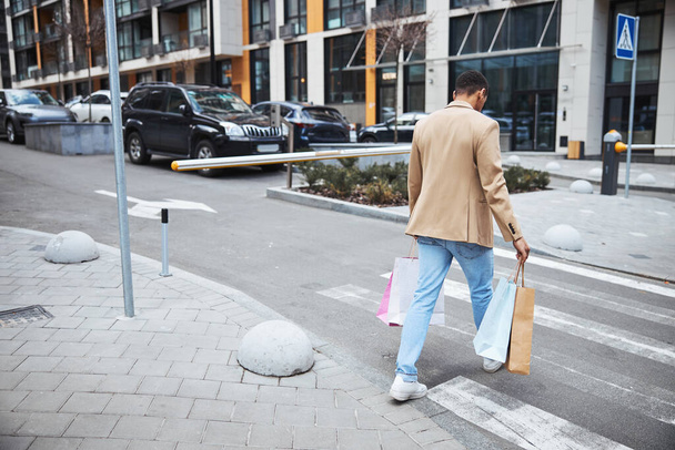 Thoughtful brunette man going home from shopping - Fotografie, Obrázek