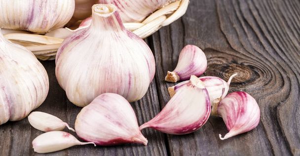 Garlic cloves and garlic bulb on a old wooden table - Photo, Image