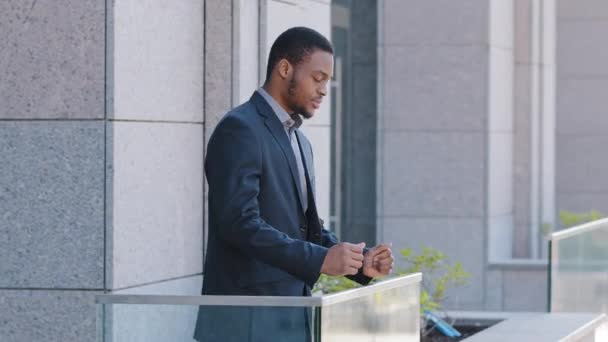Ambitny Afroamerykanin, pracownik odpoczywający w biurze. Millennial stoi na balkonie, patrząc podziwia miasto marzenie o przyszłości, czuje się szczęśliwy z kariery, pozycji w firmie - Materiał filmowy, wideo