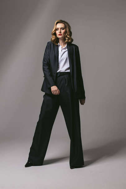 Stylish business successful confident woman full height. Businesswoman in an oversized jacket. Goal setting. office dress code. Men's black suit. Red lipstick. Financier manager realtor job.  - Photo, Image