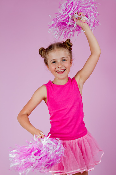 Cheerleader-Mädchen mit Bommeln, hübsches kleines Cheerleader-Kind - Foto, Bild