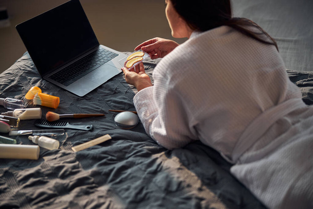 Relaxed brunette female staring at her laptop - Fotó, kép