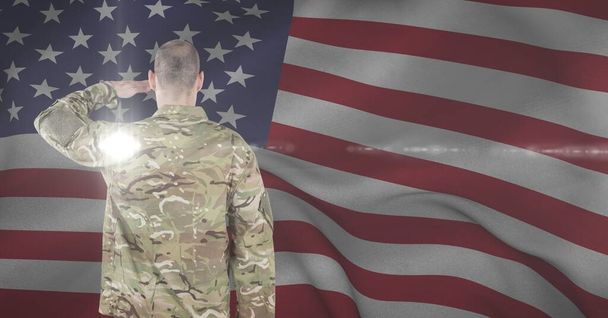 Composition of soldier saluting against american flag. united states of america patriotism and independence concept digitally generated image. - Valokuva, kuva