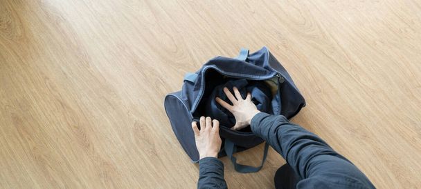 a overhead view of person packing things in the bag before travel journey start - Фото, изображение
