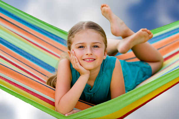 Summer vacations - lovely girl in colorful hammock - Foto, afbeelding