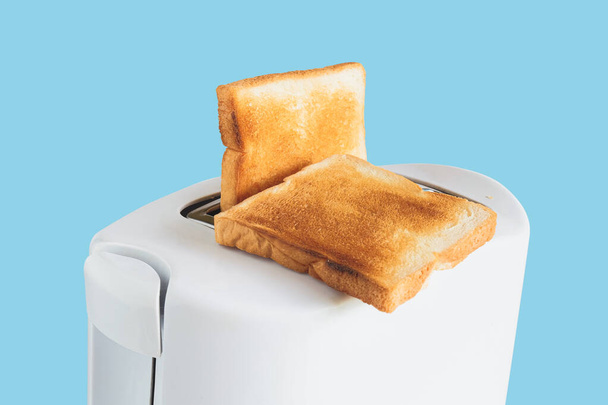 Couple of crusty toast in the toaster, close focus. - Photo, image