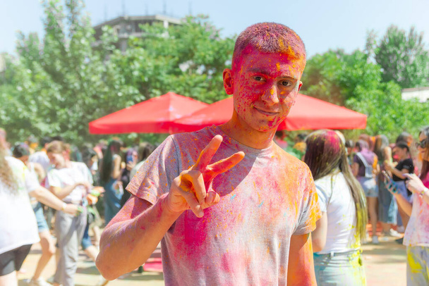 the pretty young boy in the color fest, colored faces of the peoples, color festival in india - Photo, Image