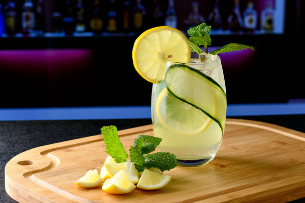 A GLASS WITH A SICILIAN LEMON DRINK IN THE BACKGROUND BLURRED IMAGE OF A NIGHT BAR ENVIRONMENT - Photo, Image