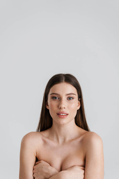 Beautiful shirtless girl posing and looking at camera isolated over white background - Fotografie, Obrázek