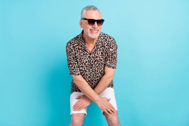 Photo of funky positive happy old man dance wear sunglass free time weekend isolated on blue color background - Fotoğraf, Görsel