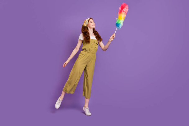Full length body size view of attractive cheerful girl enjoying wiping dust isolated over violet purple color background - 写真・画像