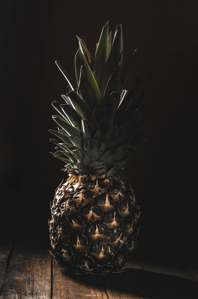 Still life of fresh pineapple on a dark background. - Фото, зображення