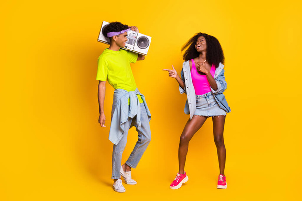 Full length body size view of handsome beautiful cheerful couple dj dancing having fun isolated over bright yellow color background - Foto, Imagen