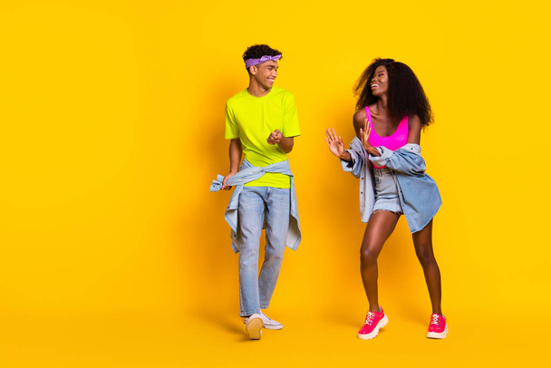 Full length body size view of attractive cheerful couple dancing enjoying free time rest isolated over bright yellow color background - Fotó, kép