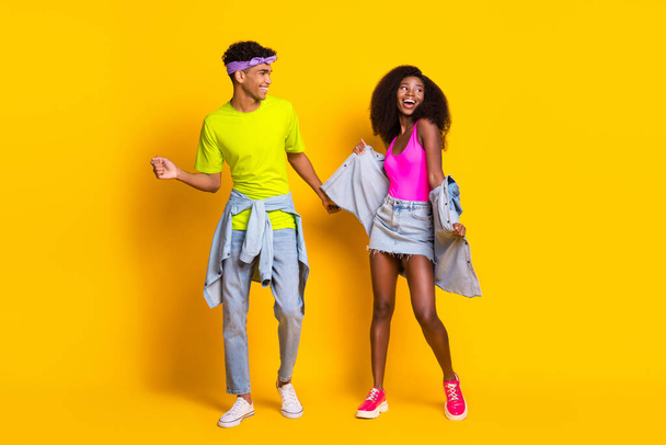 Full length body size view of attractive cheerful couple dancing good mood isolated over bright yellow color background - Foto, Bild