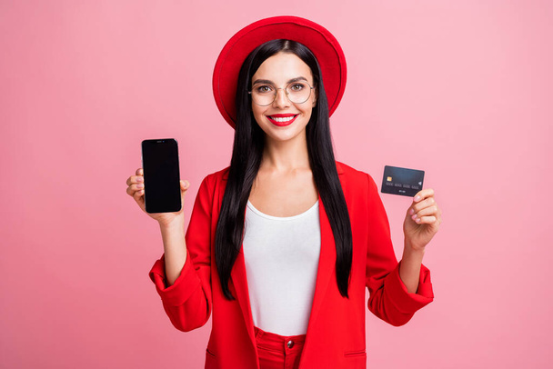 Photo portrait of woman holding credit card phone with blank space in hands isolated on pastel pink colored background - Φωτογραφία, εικόνα