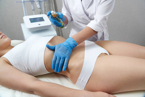 Hardware cosmetology. Young woman getting beauty treatment in spa salon - Fotografie, Obrázek