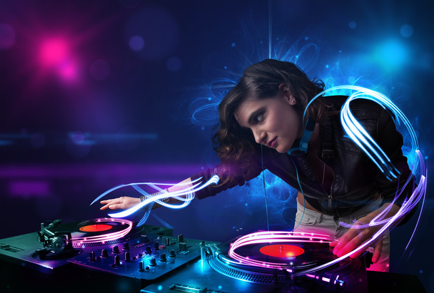 Disc jockey playing music with electro light effects and lights - Fotoğraf, Görsel