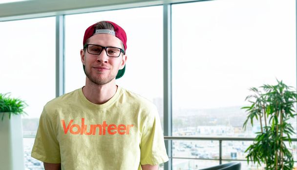 een jonge mannelijke vrijwilliger activist doet werk buiten, altruïsme en teamwork concept - Foto, afbeelding