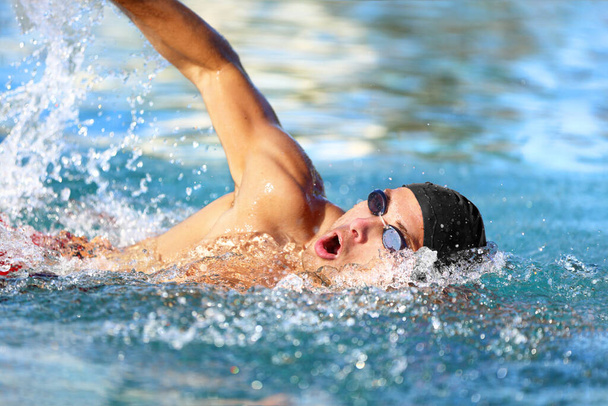 Man swimmer swimming crawl in blue ocean water - Фото, зображення