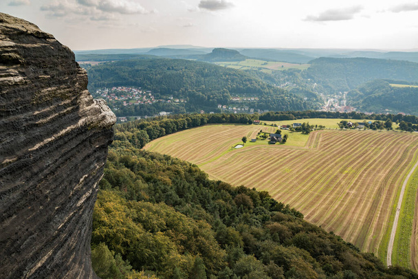 A scenic view of a vast agricultural field seen from a rocky cliff - Photo, image