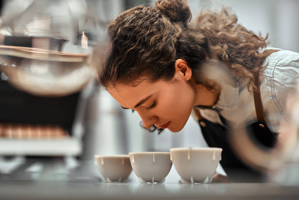 Selective focus of coffee shop workers checking coffee quality during coffee food function. Side view. Close up view. - 写真・画像