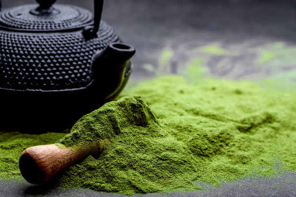 Powdered green tea and set for matcha on black background - Photo, Image