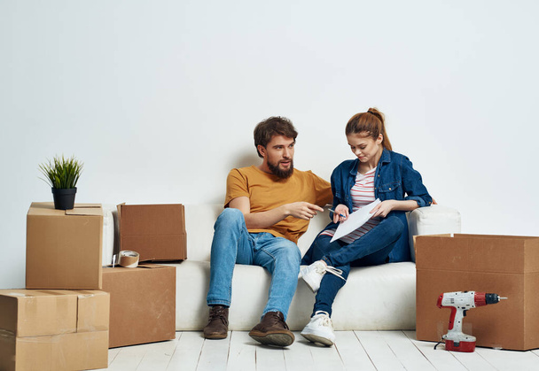 husband and wife unpack things in a new apartment interior renovation - Photo, Image