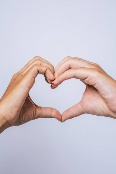 Two young women love each other hand mark heart shape. - Fotó, kép
