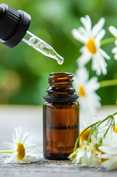 Essential oil extract of medicinal chamomile. Selective focus. Nature. - Fotó, kép