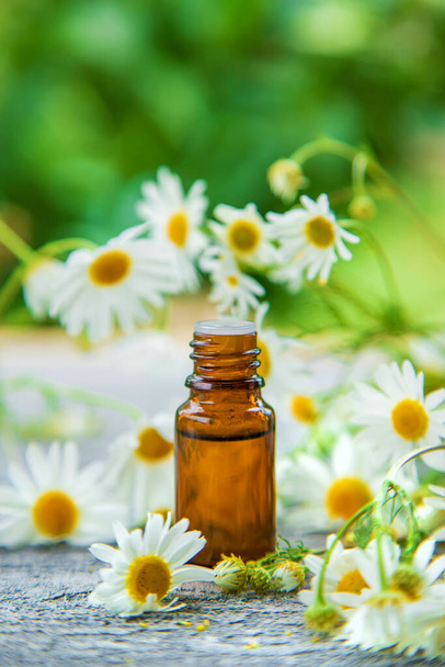 Essential oil extract of medicinal chamomile. Selective focus. Nature. - Photo, Image
