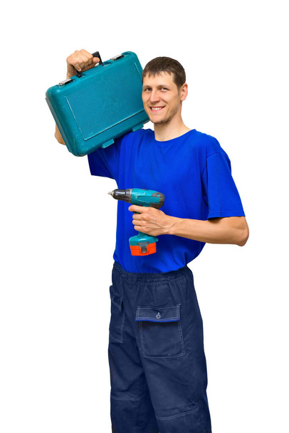 Portrait of a real mechanic-repairman or adjuster with a screwdriver and a suitcase with tools in his hands. - Photo, Image