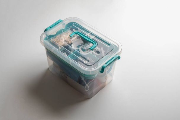 a transparent plastic container box with some things at home - Foto, Imagem