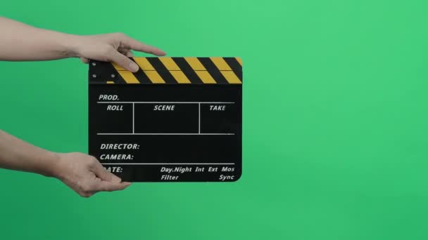 Film Slate or Movie Clapperboard with Blue Green screen background. Film crew man hold and hit film slate in the frame. Clapping film slate. Video production chroma key background. Film production.  - Πλάνα, βίντεο